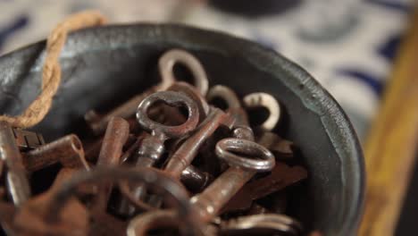 soft-pan-of-bowl-full-of-old-rusty-steel-keys-at-a-home-reception