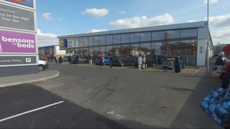 Shoppers-Queuing-At-Lidl-Car-Park-In-Ruislip-Whilst-Keeping-Social-Distancing-Measures