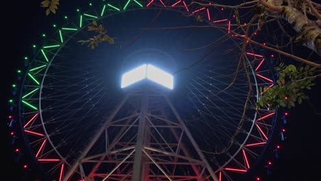 Time-Lapse-of-a-Big-Wheel-Going-Around-Illuminated-With-Colorful-Changing-Lights-In-the-Night-Time