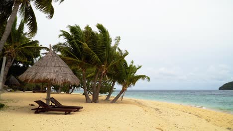 A-peaceful,-relaxing-beach-in-Fiji,-overlooking-the-waves---wide-shot