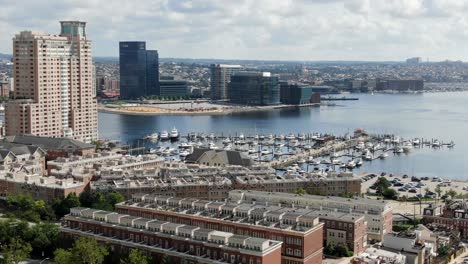 Aerial-features-upscale-waterfront-housing,-apartments,-condos-at-Baltimore-Inner-Harbor-Marina,-Patapsco-River-opens-to-Chesapeake-Bay-in-Maryland,-USA