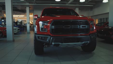 Full-Size-Red-Ford-F150-Raptor-Pickup-Truck-in-a-Dealership-Show-Room