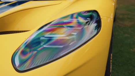 Arc-Shot-of-a-Headlight-on-a-Yellow-Ford-GT-at-Luxury-Car-Show