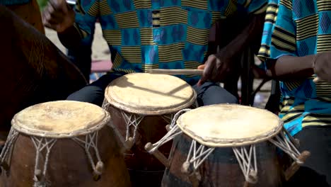 Filmed-in-slow-motion,-a-closeup-shot-shows-drummers-playing-at-a-festival-in-rural-Ghana,-West-Africa