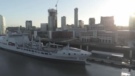 Liverpool-waterfront-aerial-view-royal-navy-military-ship-sunrise-high-rise-buildings-skyline-parallax-left