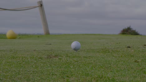 Golf-Club-striking-Golf-Ball-in-Close-Up-on-Tee