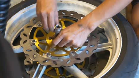 Close-up-Footage-of-Mechanic-Working-On-Disc-Brake-Installation-For-Motorcycle