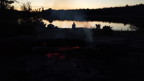 Foreground-fire-and-lone-figure-at-dusk-in-the-background