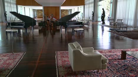 furniture-and-German-piano-in-the-music-room-of-the-Palácio-da-Alvorada,-reflected-in-the-mirrored-wall