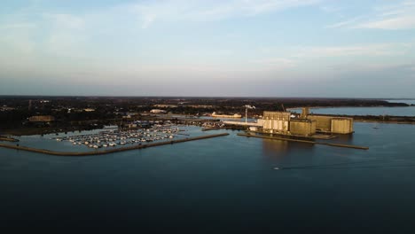 Aerial-view-of-a-motorboat-driving-past-a-marina-and-port-facilities-on-Lake-Erie
