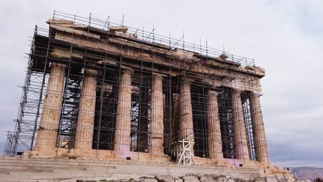 Hyper-lapse-low-angle-wide-shot-view-of-the-Parthenon-under-restoration-process-in-Athens,-Attica,-Greece
