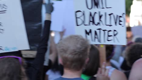 Dynamic-moving-shot-of-BLM-placards-demanding-positive-changes