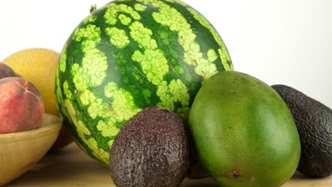 Tracking-shot-of-various-pieces-of-exotic-fruit,-including-melons-and-avocados