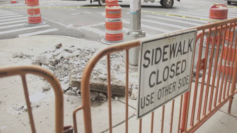 Slow-Motion-Rack-Focus-Close-Up-of-a-Sidewalk-Closed-Sign-and-Work-Site-in-NYC