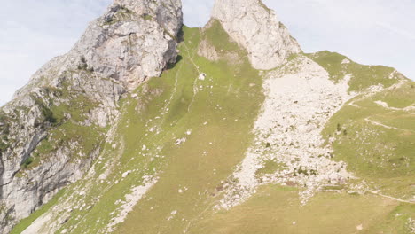 Aerial-tilt-up-of-green-mountain-slope