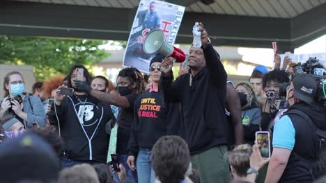 Animated-speaker-on-stage-uses-megaphone-at-Black-Lives-Matter-rally