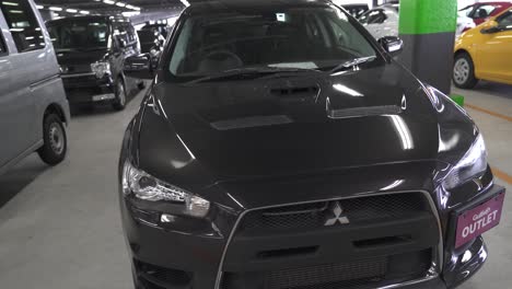 Arc-Shot-of-a-Black-Mitsubishi-Evo-X-Parked-in-a-Parking-Deck