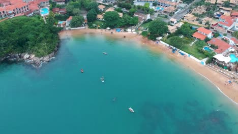 Drone-view-of-high-altitude-boats-in-the-water-lagoon-in-Brazil,-Rio-de-Janeiro-beach-shore