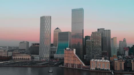 Rising-Drone-aerial-shot-of-London-Canary-Wharf-at-sunset