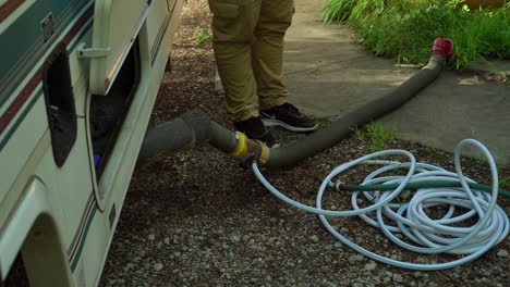 A-coachmen-grey-water-hose-on-the-ground-after-being-flushed