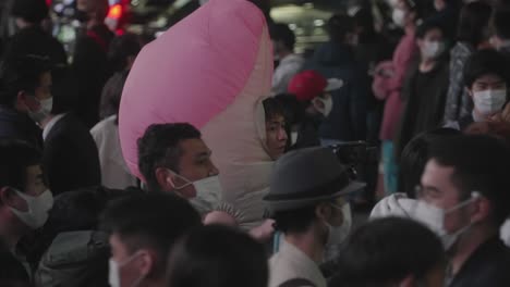 Japanese-Guy-In-A-Dick-Costume-Strolling-At-Shibuya-Crossing-In-Tokyo,-Japan-On-Halloween-Night---slow-motion