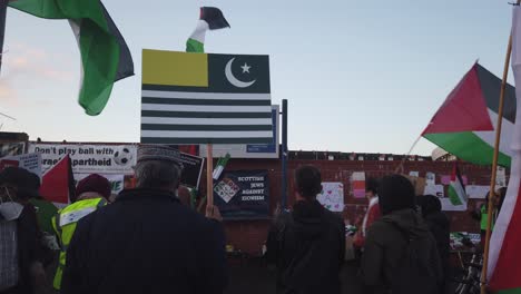 A-pro-Palestinian-protester-holds-up-the-Flag-of-Azad-Kashmir-outside-Hampden-Park