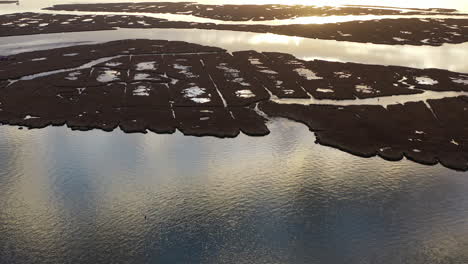 An-aerial-shot-over-Baldwin-Bay-near-Freeport,-NY-at-sunset