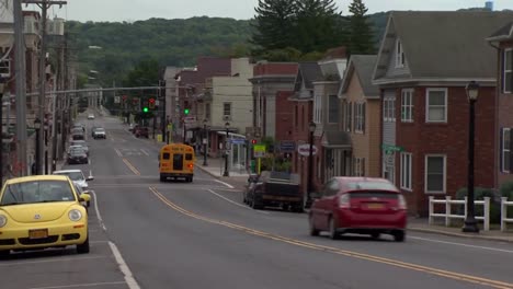 SCHOOL-BUS-DRIVING-IN-SMALL-TOWN-AMERICA
