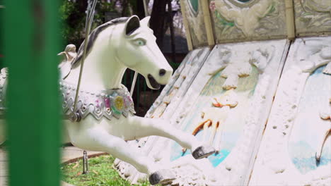 Close-up-of-a-white-carousel-horse-in-an-amusement-park