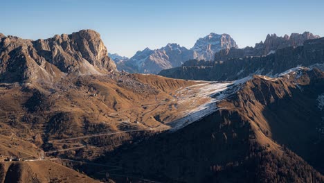 Looking-over-at-Passo-Giau,-Cima-Ambrizzola-and-Punta-Sorapiss-while-the-shadows-move-across-the-landscape-as-morning-turns-into-day