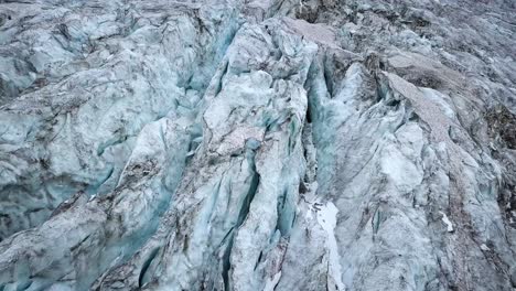 Aerial-view-of-a-mountain-glacier-with-a-lot-of-craks-melting-in-the-Swiss-alps