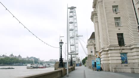Empty-London-in-Lockdown-streets-with-closed-static-Millennium-Wheel,-during-coronavirus-Pandemic,-on-an-overcast-day