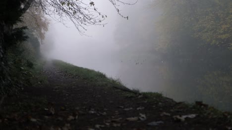 Canal-pathway-in-foggy-mist-weather-wide-landscape-panning-shot