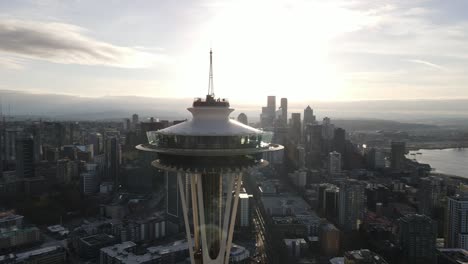 Brilliant-sunrise-backlights-a-beautiful-Seattle-Space-Needle-and-city-skyline,-aerial-orbit