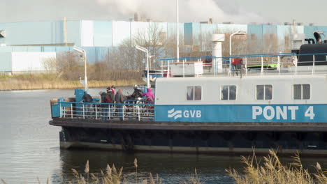 Amsterdam-ferry-crossing-river-with-passengers-on-board