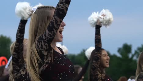 High-school-cheerleaders-cheer-with-the-crowd-at-a-home-football-game