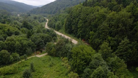Aerial-view-of-a-road-in-the-Carpathian-Mountains,-cloudy-day,-in-Ukraine---dolly,-drone-shot