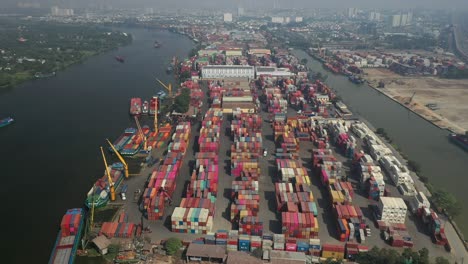 Drone-view-of-Saigon-River,-Ho-Chi-Minh-City-and-container-freight-terminal-on-a-sunny-day