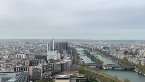 A-view-of-Paris-from-the-Eiffel-Tower,-including-four-bridges---Pont-de-Bir-Hakeim,-Pont-Rouelle,-Pont-de-Grenelle,-and-Pont-Mirabeau---as-well-as-L'île-aux-Cygnes-island,-which-is-artificial