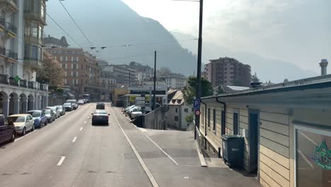 Views-while-driving-and-arriving-and-driving-through-the-city-of-Montreux,-Switzerland,-next-to-Lake-Geneva