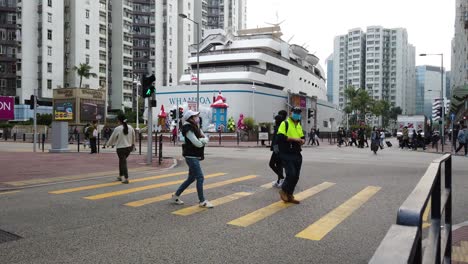 People-crossing-the-street-in-Downtown-Hong-Kong-Whampoa-area,-Aerial-view