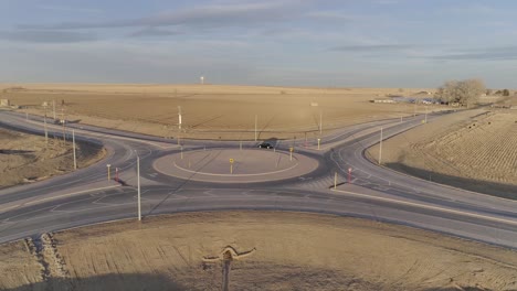 A-modern-roundabout-in-the-middle-of-nowhere,-Cars-navigate-a-circle