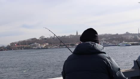 Premium Photo  Man holding a fishing rod standing on a bridge