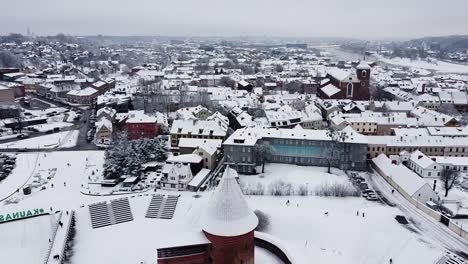 Drone-flying-towards-Kaunas-castle-in-high-angle-winter-season-shot