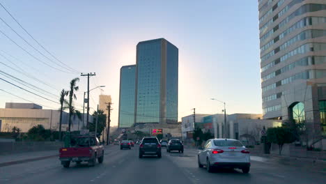 Driving-by-twin-towers-of-the-Grand-Hotel-in-Tijuana,-Baja-California