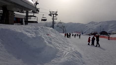 Gudauri-Ski-Resort-full-of-tourists-and-local-people-beside-a-ski-lift-station-during-winter-morning-in-Georgia