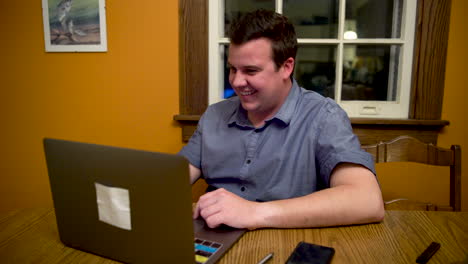 Man-very-happy-about-things-he's-seeing-on-his-laptop-computer