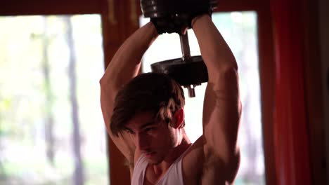 Tight-shot-of-a-teen-bodybuilder-doing-a-military-press-or-tricep-extension-behind-his-head-with-a-heavy-group-of-weights