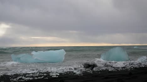Waves-Crashing-Over-Blue-Icebergs