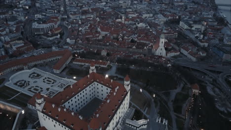 Aerial-shot---flying-over-Bratislava-castle-and-old-town-at-twilight